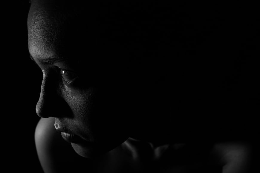Dramatic Black and White Profile Portrait of Woman in Shadows