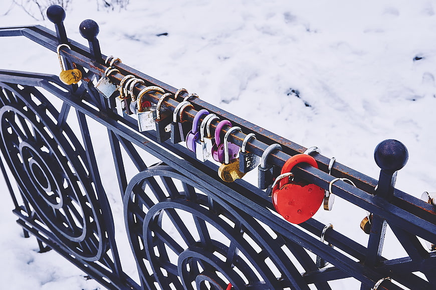 Colorful Love Locks on Snowy Iron Railing