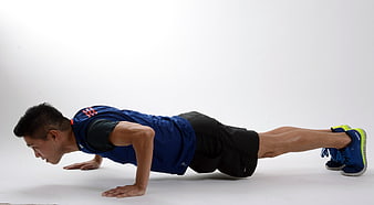 Male Athlete Performing Push-Up Exercise In Blue Sportswear