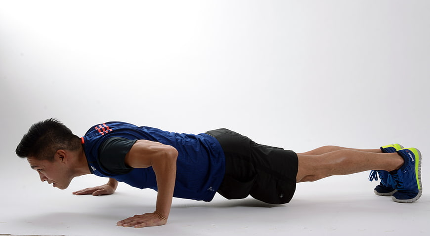 Male Athlete Performing Push-Up Exercise In Blue Sportswear