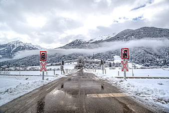 Wet Road at Snowy Mountain Railroad Crossing