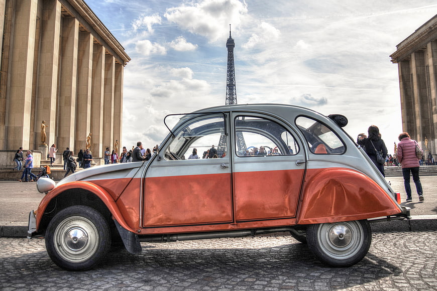 Vintage Citroën 2CV parked in Paris with Eiffel Tower