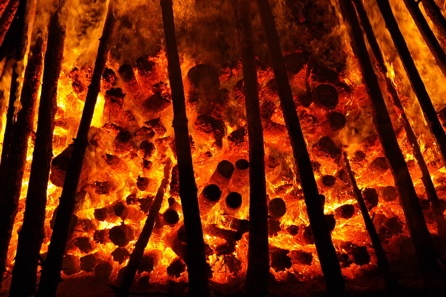 Intense Bonfire Flames Burning Through Wooden Logs at Night