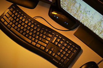 Black Microsoft Keyboard and Monitor on Desk