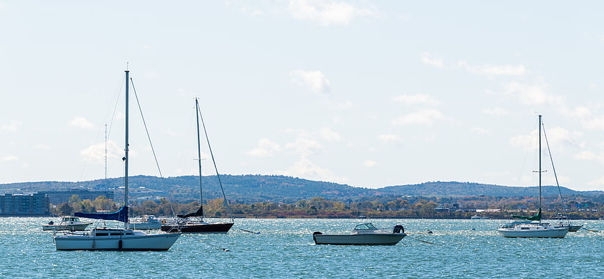 Sailboats Anchored in Harbor with Hills Background
