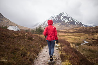 Woman in Red Jacket Hiking Mountain Trail
