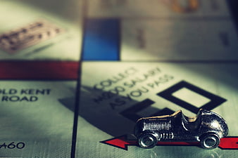 Vintage Monopoly Car Token on Game Board Closeup