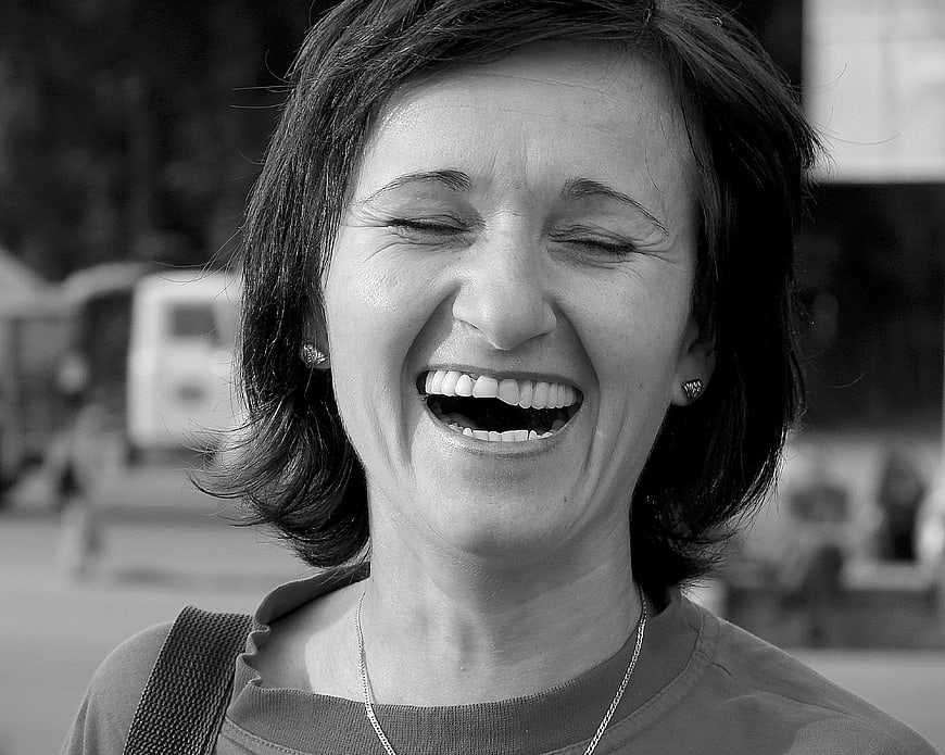 Black and white portrait of a laughing woman with short hair