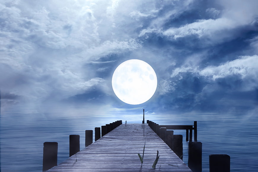 Wooden Pier Under Giant Full Moon and Cloudy Night Sky