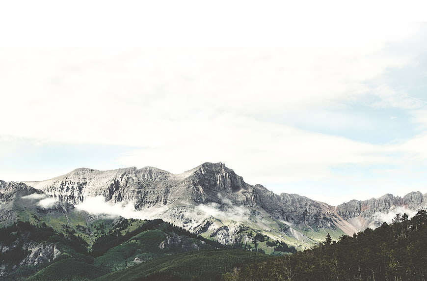 Majestic Mountain Landscape with Misty Clouds and Forest