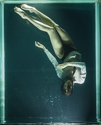 Underwater portrait of woman floating in tank