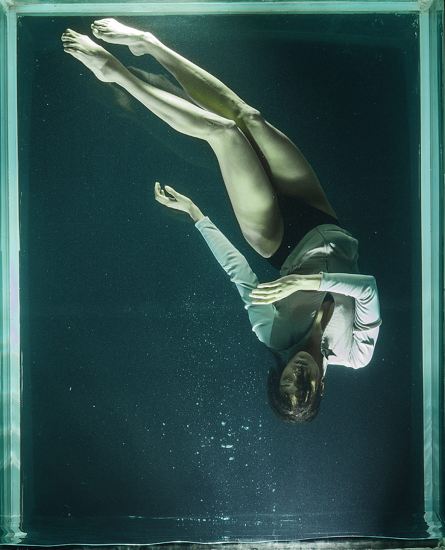 Underwater portrait of woman floating in tank