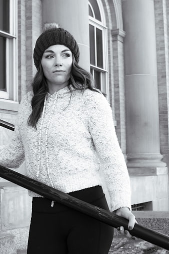 Young Woman in Beanie and Fleece Jacket on Outdoor Stairs