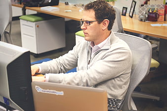Man working at computer in modern office workspace