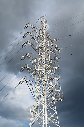 High Voltage Power Line Tower Against Stormy Sky