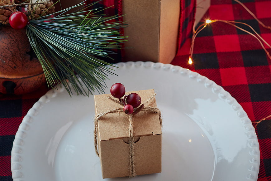 Christmas Gift Box on White Plate with Plaid Tablecloth