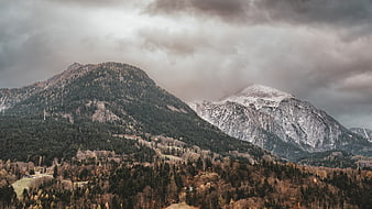Dramatic Alpine Mountain Landscape With Snowy Peaks And Forest