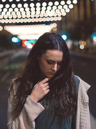 Pensive Woman with Bokeh Lights at Night