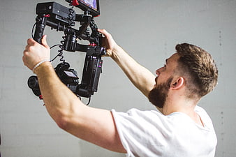 Cameraman operating professional gimbal stabilizer