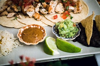Mexican chicken tacos with guacamole, salsa, and rice