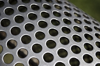 Close-up of perforated metal sheet with circular holes