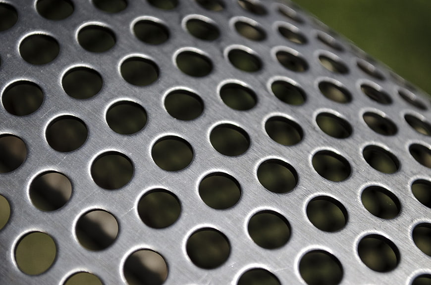 Close-up of perforated metal sheet with circular holes