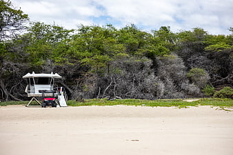 White Lifeguard Tower and Red ATV on Sandy Beach