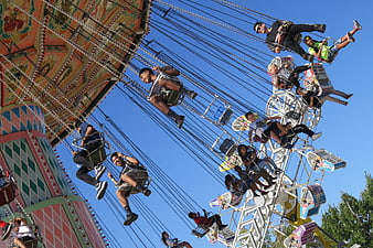 Low angle view of people on a carnival swing ride