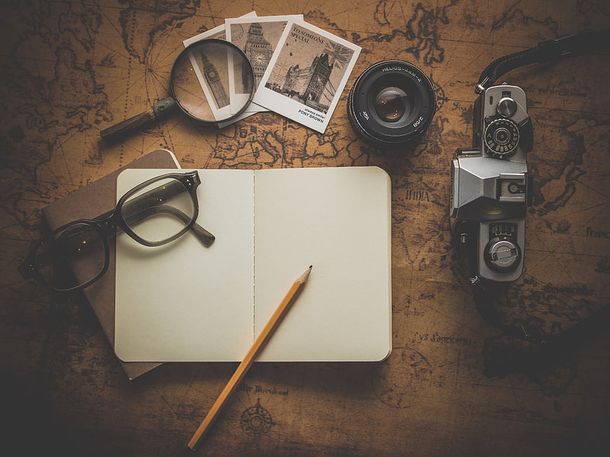 Vintage Travel Planning Flat Lay with Camera, Map, and Notebook