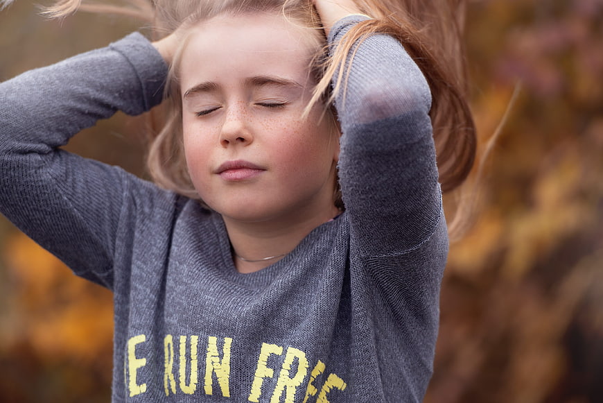 Young Girl with Closed Eyes in Autumn Outdoors