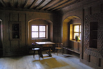 Rustic wooden interior with antique furniture and carved paneling
