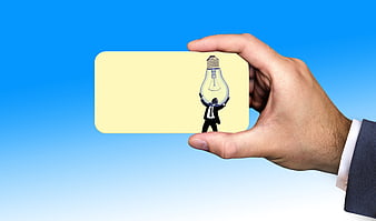 Businessman hand holding yellow business card with lightbulb icon on blue background