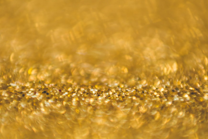 Abstract golden liquid texture with bubbles and blur