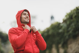 Happy Man in Red Hoodie Looking Up Outdoors