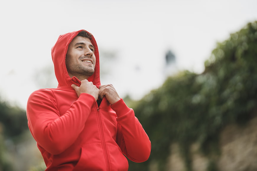 Happy Man in Red Hoodie Looking Up Outdoors