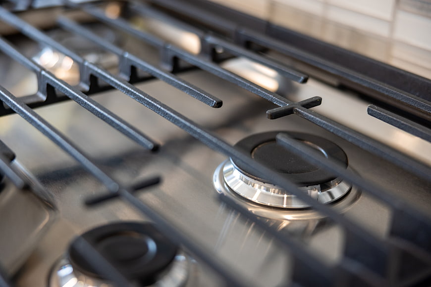 Close-up of stainless steel gas stove burner and grates