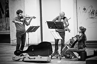 Street musicians playing violin and cello in an urban setting