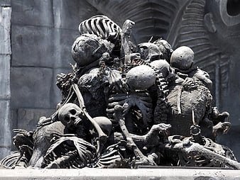Detailed Sculpture of Piled Human Skulls and Skeletons