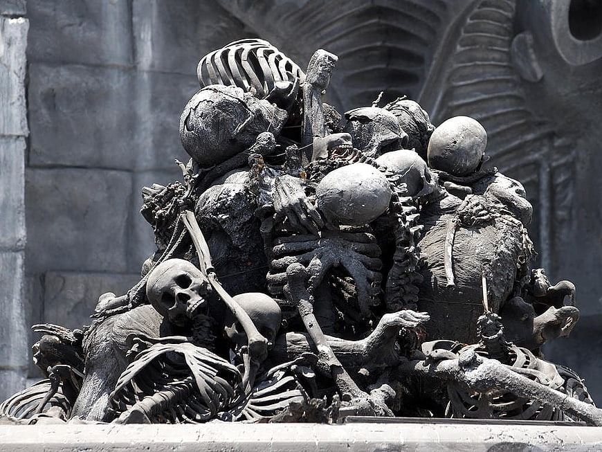 Detailed Sculpture of Piled Human Skulls and Skeletons