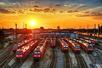 Red Locomotives in Railway Depot at Golden Sunset
