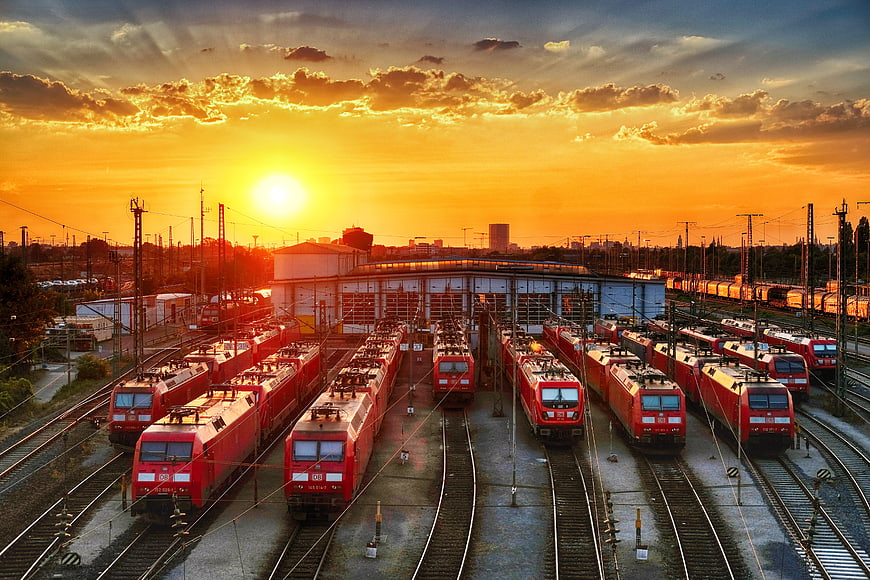 Red Locomotives in Railway Depot at Golden Sunset