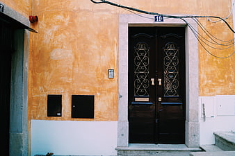 Vintage Orange Building Facade with Dark Wooden Door