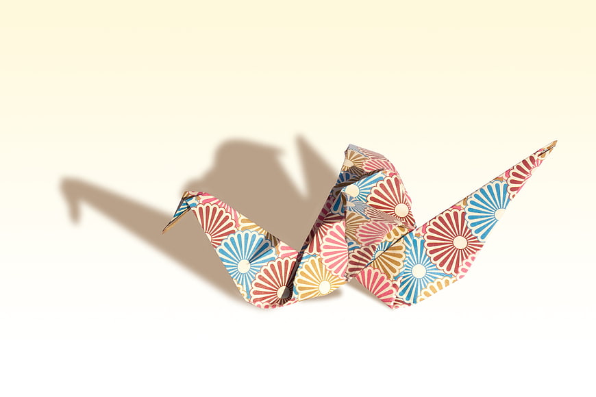 Colorful Patterned Origami Crane on White Background