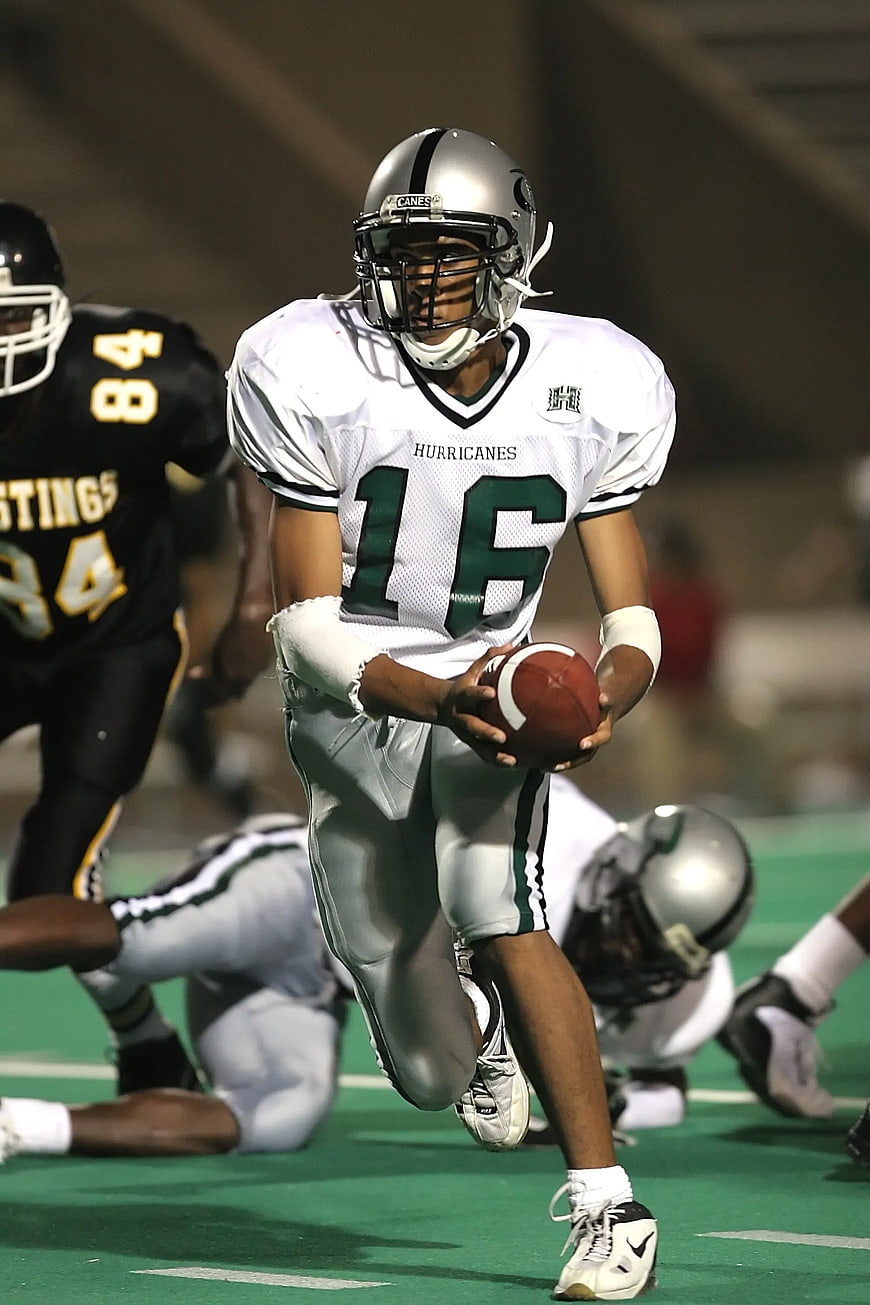Football Player in White Jersey Running with Ball