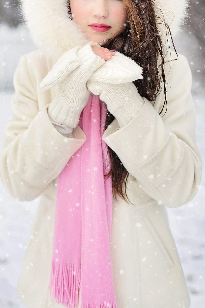 Woman in White Coat and Pink Scarf in Snow