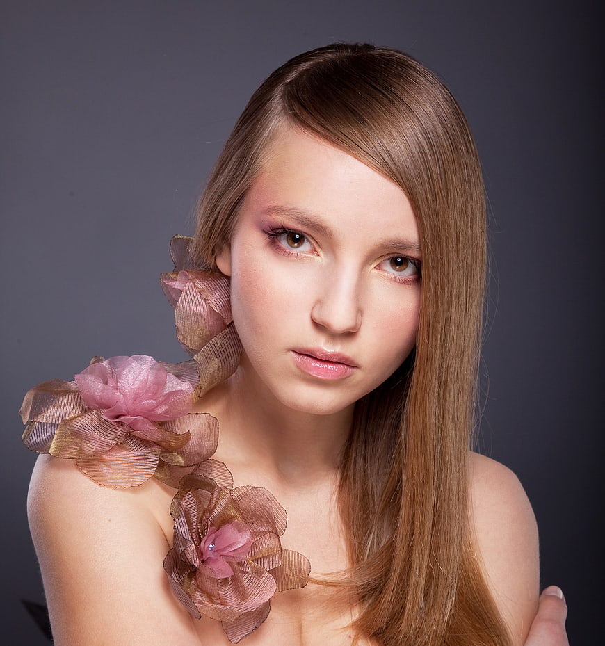 Studio Portrait of Young Woman With Floral Shoulder Accents