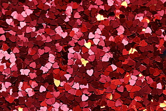 Close-up of red and pink heart-shaped confetti background