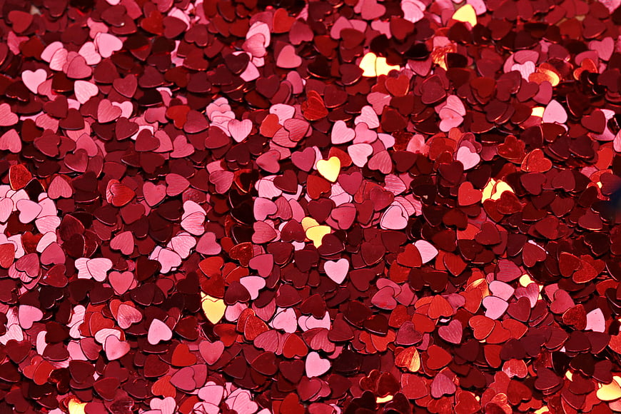 Close-up of red and pink heart-shaped confetti background
