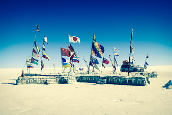 International flags on salt monument at Uyuni Salt Flats