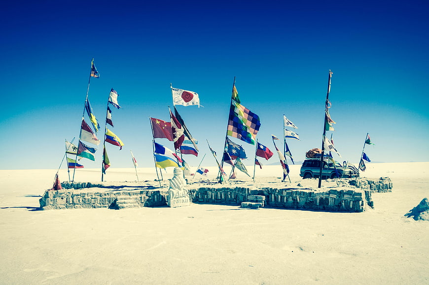 International flags on salt monument at Uyuni Salt Flats